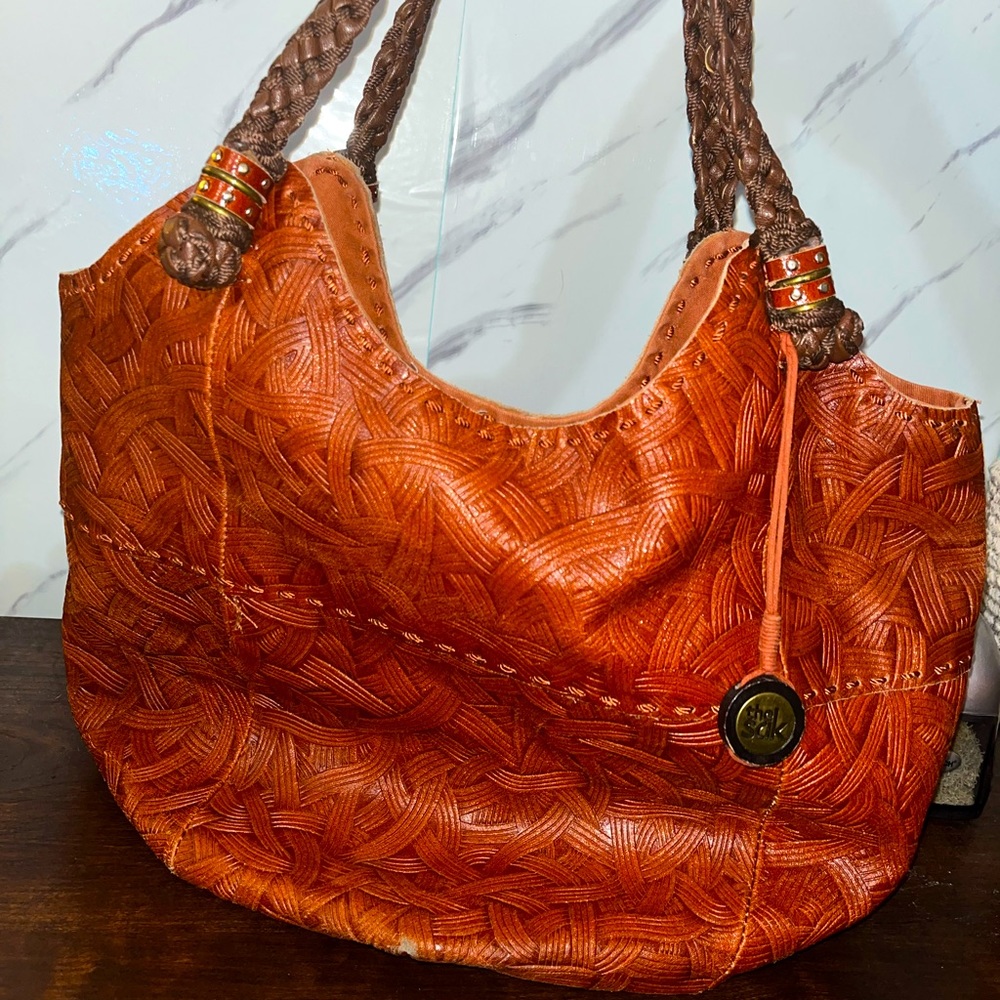 The Sak Bucket Bag with Chestnut Etched Leather and Woven Dark Leather Straps